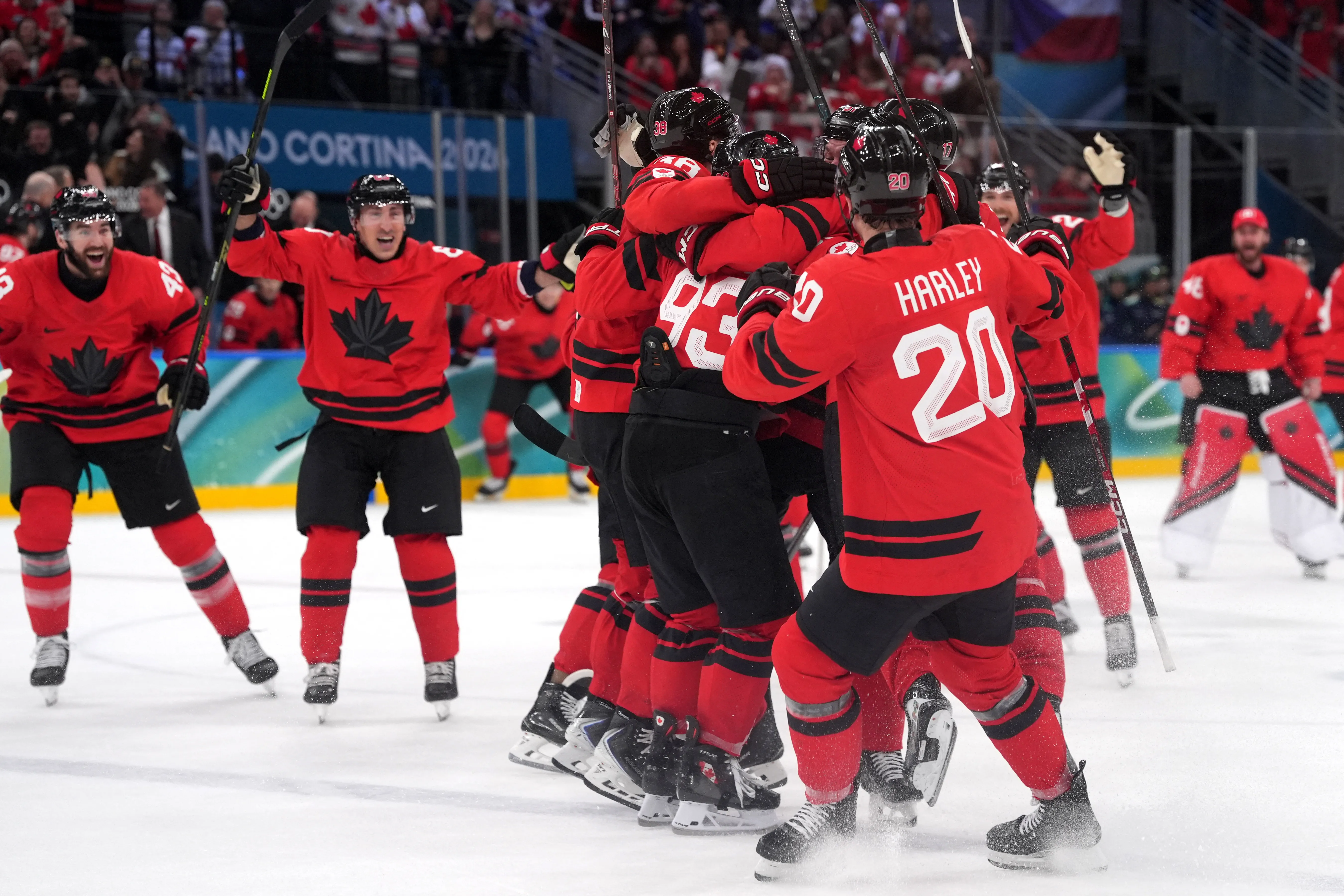 Mitch Marner of Canada celebrates with teammates after scoring their fourth goal in overtime to win the men's hockey quarterfinal against Czechia.