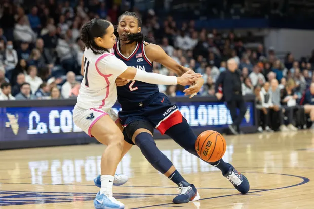 Villanova guard Jasmine Bascoe (11) gets the ball away from UConn guard Kk Arnold (2) during the first half of an NCAA college basketball game, Wednesday, Feb. 18, 2026, in Villanova, Pa. (AP Photo/Laurence Kesterson)