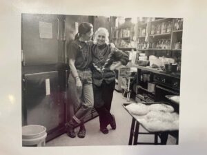 Noel Furie and Selma Miriam arm in arm in the Bloodroot kitchen. Accessed through the Yale Special Archives Bloodroot Collective records. Used through Public Domain. 