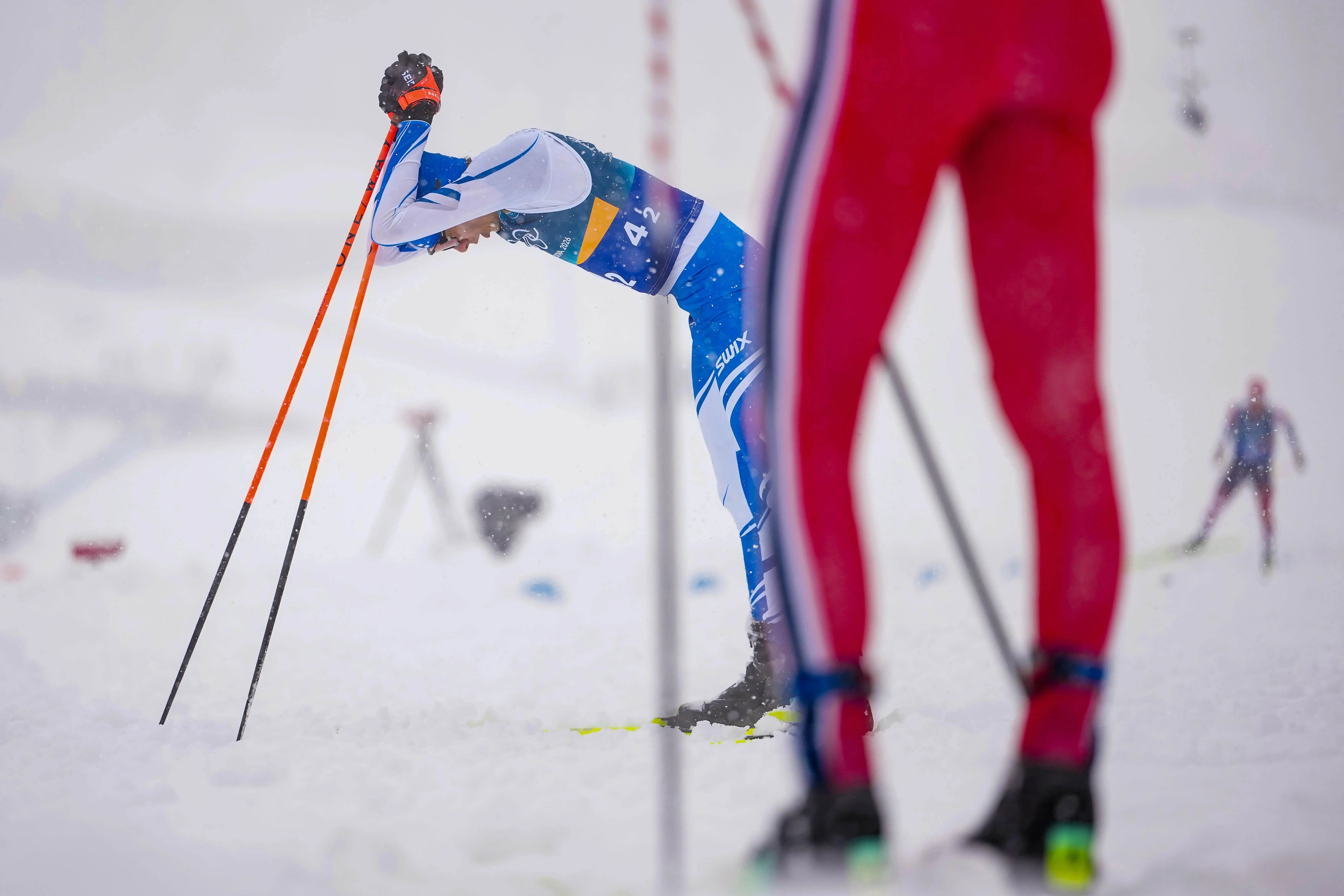 Eero Hirvonen, of Finland, reacts after crossing the finish line...