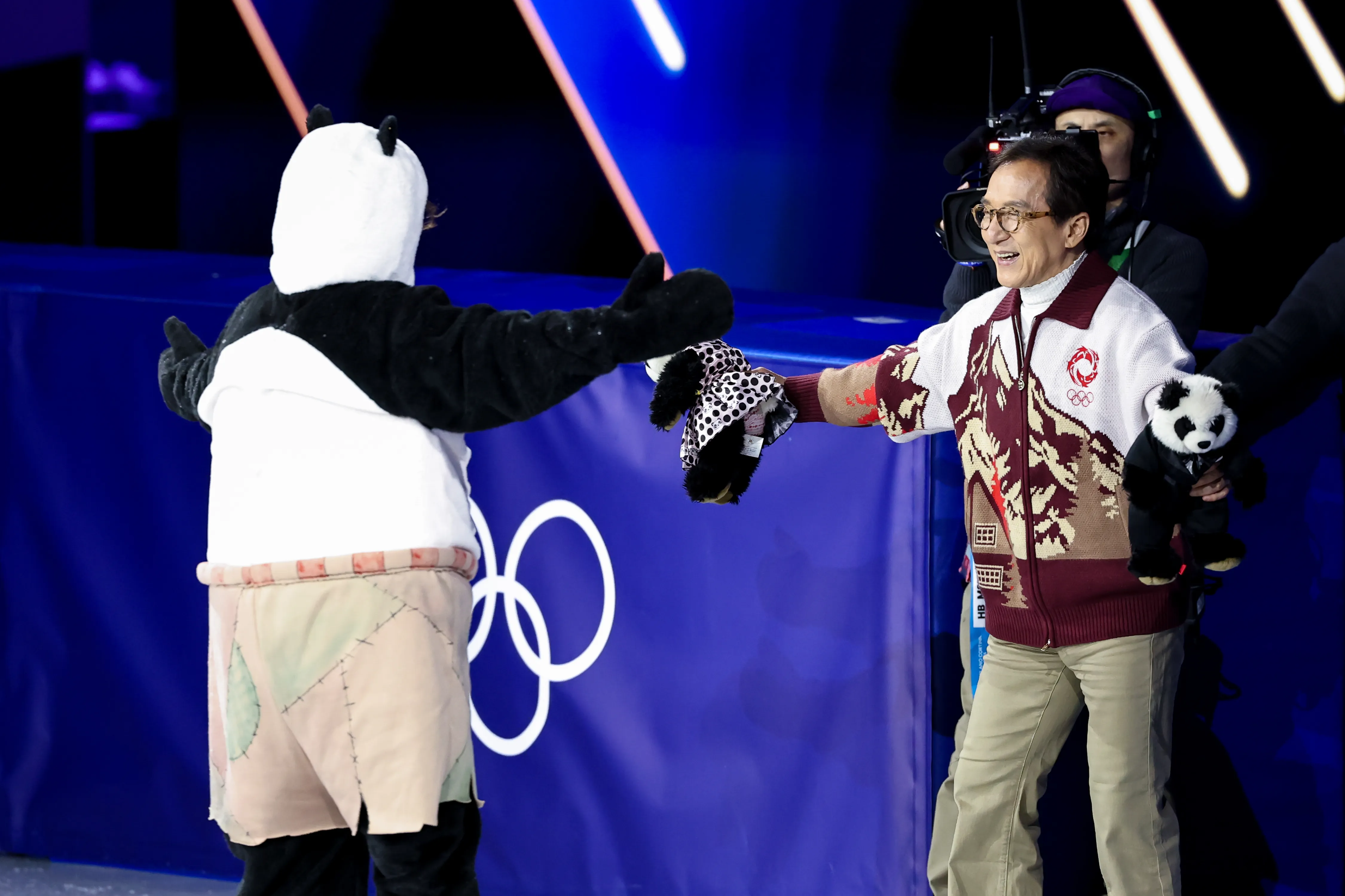 Mikhail Shaidorov of Team Kazakhstan greets Jackie Chan after his Men Single Skating routine during a Figure Skating Exhibition Gala.
