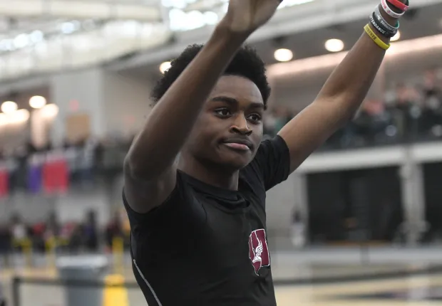 Shelldon Simpson II celebrates after breaking the 300 meter meet record at the State Open indoor track and field championships Saturday at the Floyd Little Athletic Center in New Haven. Simpson II finished in 33.90 seconds. (Photo by Lori Riley)