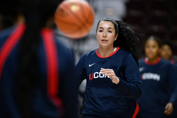 UConn guard Caroline Ducharme warms up before an exhibition NCAA college basketball game, Monday, Oct. 13, 2025, in Uncasville, Conn. (AP Photo/Jessica Hill)