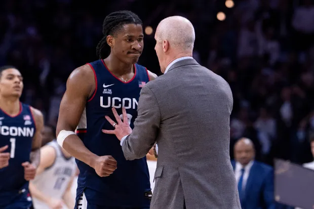 UConn Silas Demary Jr., left, listens to head coach Don Hurley, right, during an NCAA college basketball game against Villanova, Saturday, Feb. 21, 2026, in Philadelphia. (AP Photo/Chris Szagola)