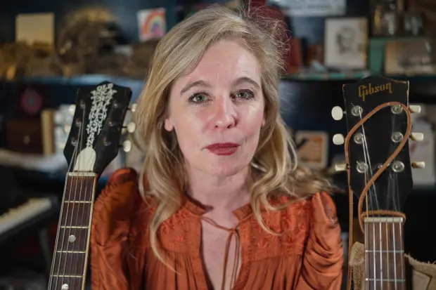 Tift Merritt, co-chair of the Artist Rights Alliance, poses for a photo with her guitars.