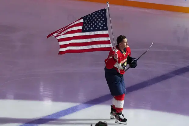 Florida Panthers left wing Matthew Tkachuk skates with an American flag before an NHL hockey game