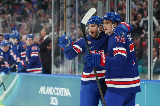 Former UConn star Tage Thompson, right, celebrates with Noah Hanifin after Hanifin's second-period goal in the Team USA's 6-3 win over Denmark in an Olympic preliminary game on Saturday at Milano Santagiulia Ice Hockey Arena. (Maja Hitij/Getty Images)