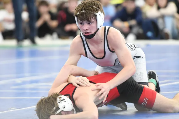 Xavier Zack Dixon (in white) defeated Somers' Will Accorsi, last year's State Open champion, in a major decision, 12-0, Saturday in the 120 pound class at the State Open wrestling championships at Floyd Little Athletic Center in New Haven. (Photo by Lori Riley)