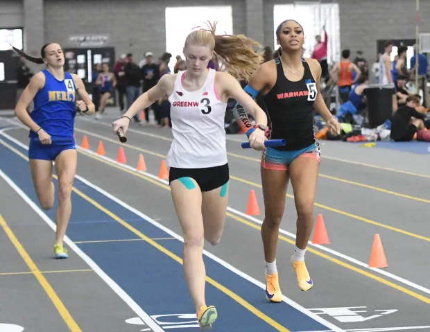Greenwich's Eliana Daplyn edges Bloomfield's D'Asia Duncan in the sprint medley relay Saturday at the State Open indoor track and field championships at Floyd Little Athletic Center in New Haven. (Photo by Lori Riley)