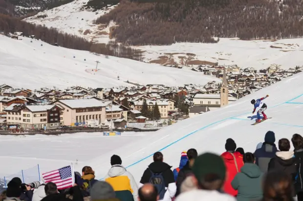 Czechia's Radek Houser competes during the men's snowboard cross qualifications at the 2026 Winter Olympics, in Livigno, Italy, Thursday, Feb. 12, 2026. (AP Photo/Lindsey Wasson)