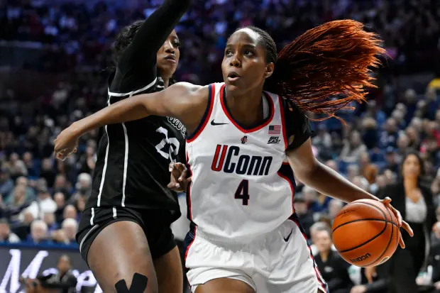 UConn guard Blanca Quinonez (4) is guarded by Providence forward Teneisia Brown in the first half of an NCAA college basketball game, Sunday, Feb. 22, 2026, in Storrs, Conn. (AP Photo/Jessica Hill)