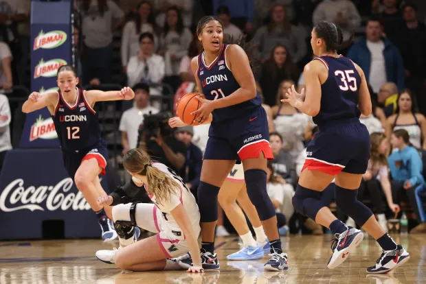 VILLANOVA, PENNSYLVANIA - FEBRUARY 18: Sarah Strong #21 of the UConn Huskies picks up a loose ball against the Villanova Wildcats during the first half at Finneran Pavilion on February 18, 2026 in Villanova, Pennsylvania. (Photo by Bill Streicher/Getty Images)