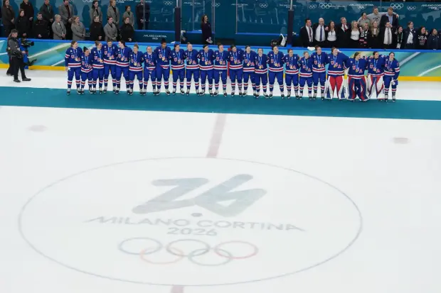 United States players and coaches stand during the playing of the national anthem after winning the women's ice hockey gold medal game at the 2026 Winter Olympics, in Milan, Italy, Thursday, Feb. 19, 2026. (AP Photo/Carolyn Kaster)