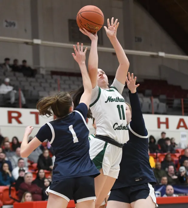 Northwest Catholic's Lilyan Johnson (11) goes up against Rocky Hill's Kelsey LaMay (1) in the first half of the CCC girls basketball championship Monday night at the University of Hartford. (Photo by Lori Riley)