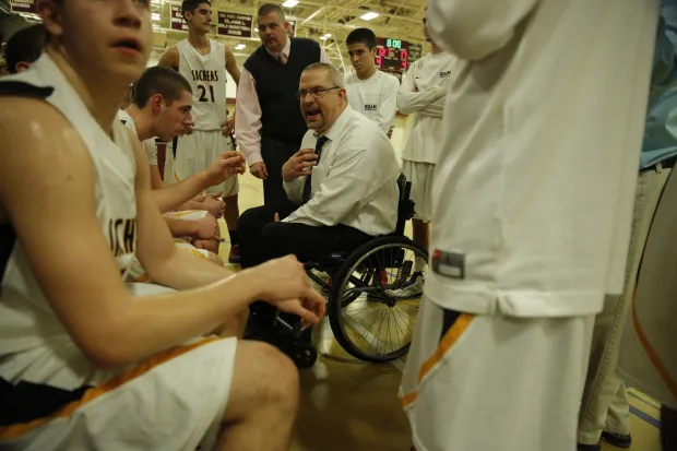 Steve Emt talks to his RHAM basketball players as they take on Farmington during a state tournament game. (Courant file photo)