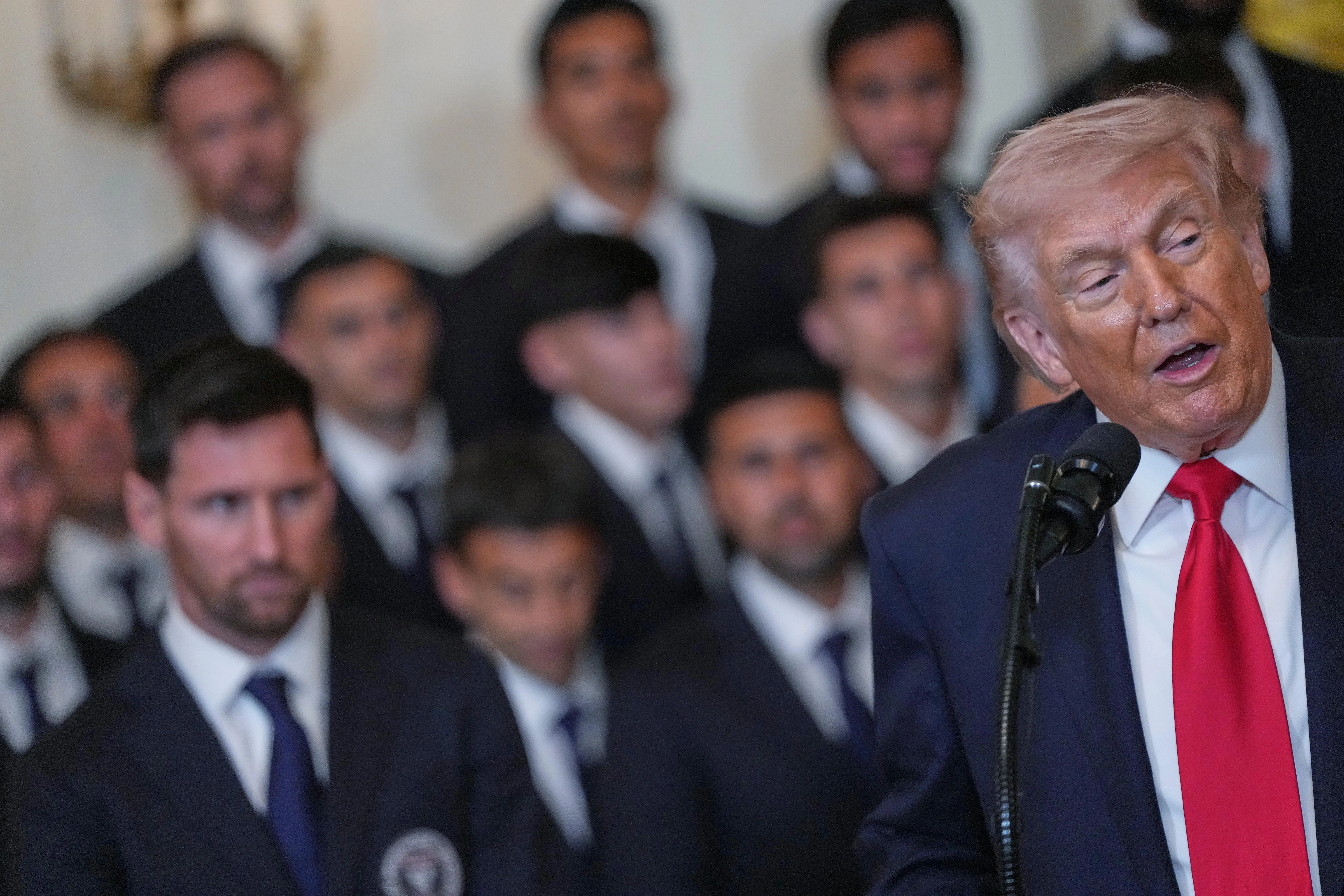 Lionel Messi, left, and teammates listen to President Donald Trump...