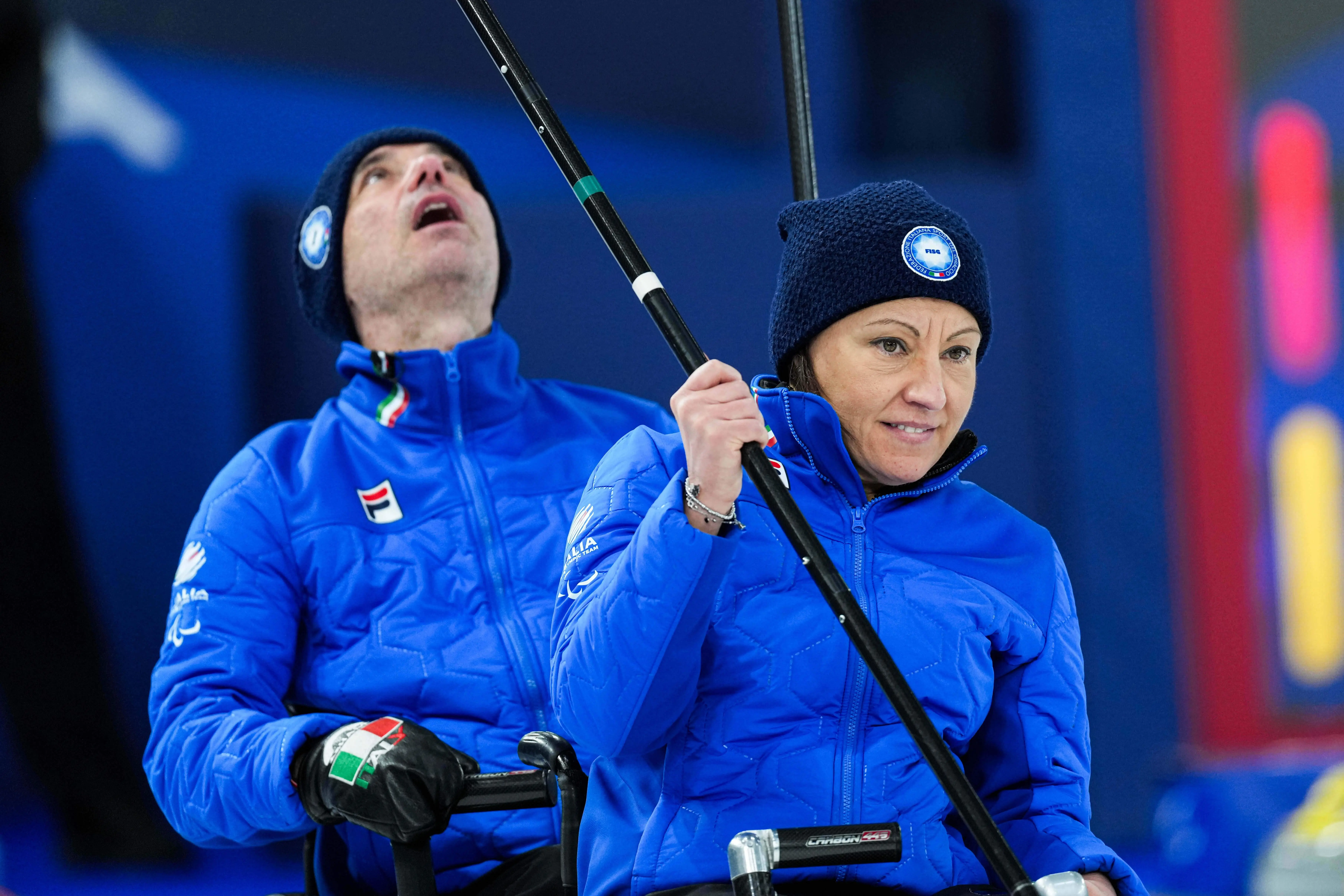 Italy's Orietta Berto and Paolo Ioriatti compete against China during a wheelchair curling mixed doubles match.