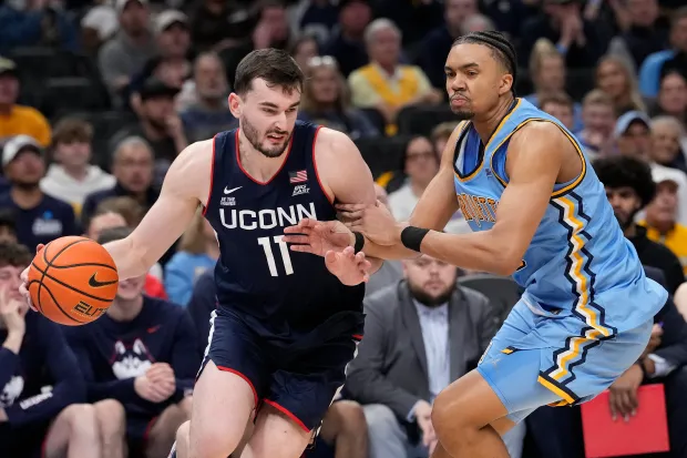 UConn's Alex Karaban dribbles the ball against Royce Parham #13 of the Marquette Golden Eagles during the second half at Fiserv Forum on March 07, 2026 in Milwaukee. (Patrick McDermott/Getty Images)