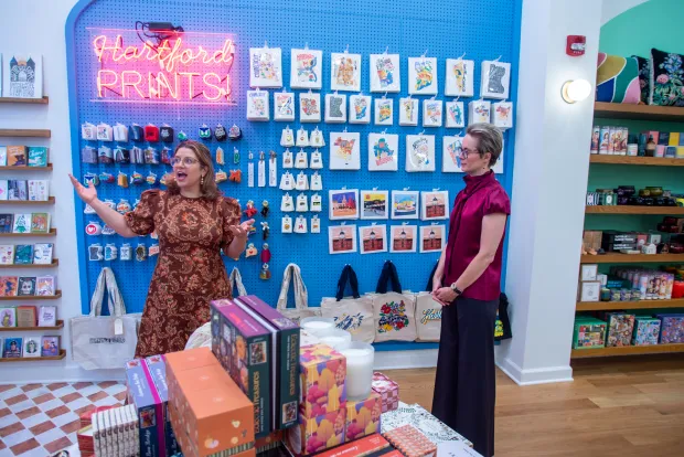 Hartford Prints! owner Rory Gale, left, walks through her newly renovated store with architect Josye Utick of Site Nouveau LLC on Pratt Street in Hartford prior to a grand reopening last fall. (Aaron Flaum/Hartford Courant)