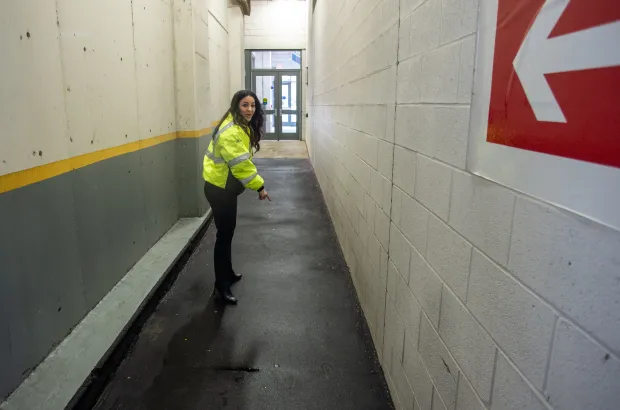 Hartford Parking Authority CEO Khouloud "Kay" Al Mannai shows the drab hallway that leads to the Hartford Stage entrance and talks plans for sprucing it up. (Aaron Flaum/Hartford Courant)