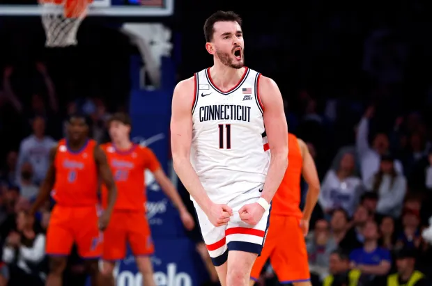 UConn forward Alex Karaban (11) reacts after making a three point shot against Florida during the second half of an NCAA basketball game, Tuesday, Dec. 9, 2025, in New York. (AP Photo/Noah K. Murray)