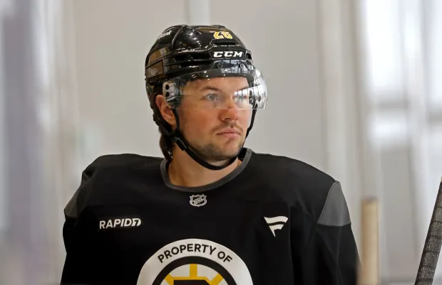 Boston Bruins defenseman Andrew Peeke (26) looks on as the Bruins participate in a practice. (Staff photo by Stuart Cahill)