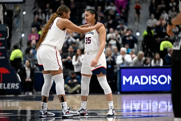 UConn forward Sarah Strong, left, talks with guard Azzi Fudd, right, before the tip-off in an NCAA college basketball game against Georgetown, Thursday, Feb. 26, 2026, in Hartford, Conn. (AP Photo/Jessica Hill)