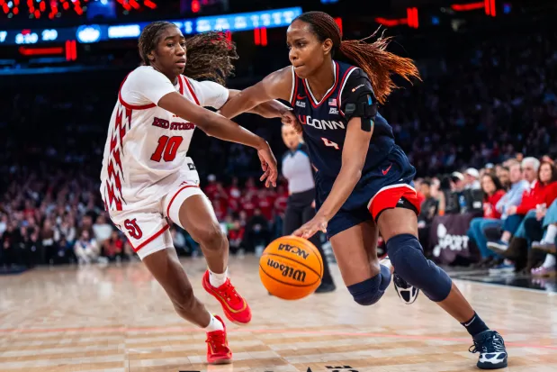 UConn guard Blanca Quinonez (4), guarded by St. John's guard Brooke Moore (10), heads toward the basket during the first half of an NCAA women's college basketball game, Sunday, March 1, 2026, in New York. (AP Photo/Angelina Katsanis)