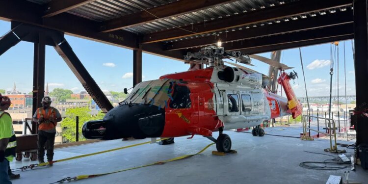Historic helicopter hoisted into National Coast Guard Museum under construction in New London