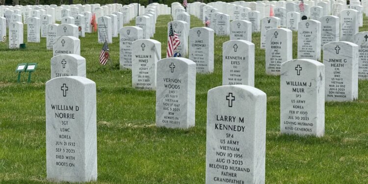 Volunteers place nearly 14,000 flags at veterans cemetery ahead of Memorial Day